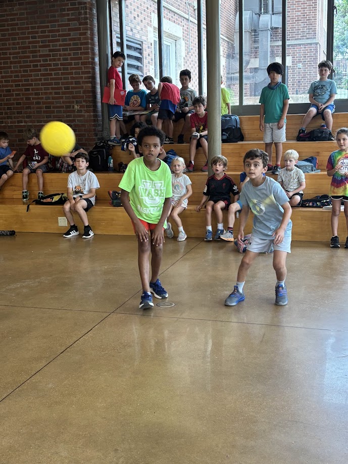 Kids playing dodgeball in a gym